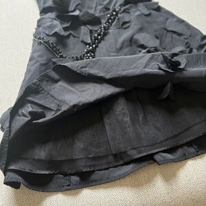 A black strapless Bebe dress.